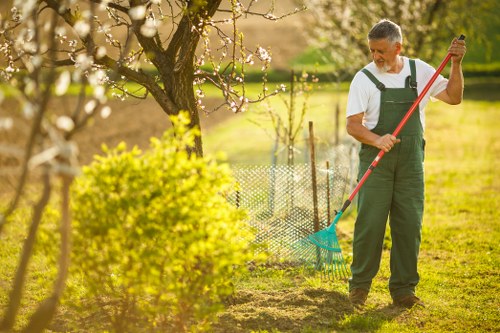 Worker using proper safety equipment during garden maintenance